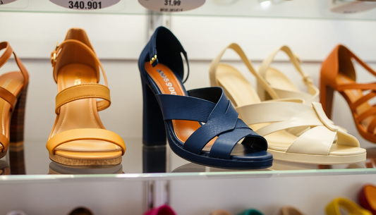 A variety of stylish summer shoes displayed on shelves