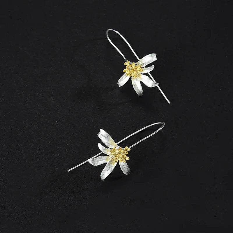 Jewelrieshub elegant floral dangle earrings with silver petals and gold center on black background