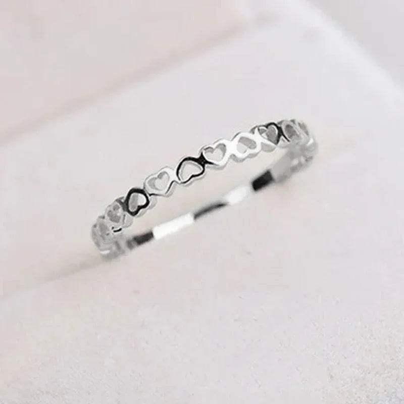 Silver hollow heart finger ring with interlinked heart shapes from Jewelrieshub