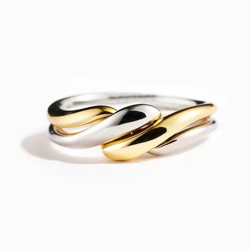 Women's gold and silver statement ring with twisted design from Jewelrieshub on white background